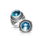 Handcrafted sterling silver Bali ring with round Blue Topaz Quartz and detailed rope scrollwork.